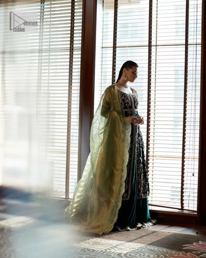 Outfits that define you. DeemasFashion presents the party wear in deep green colour which is adorned with light golden embroidery. It is enhanced with tilla, dabka, kora Kundan and the real magic of Zardozi. The round neckline makes this epitome of beauty. Furthermore, the full sleeves of the front open gown intensify the beauty of the outfit. It is coordinated with a plain lehenga with a border embellished to make you feel fresh and bold at the same time. Complete this attire with a dupatta in ivory colour which is ornamented with a four-sided embellished border to give a royal touch.