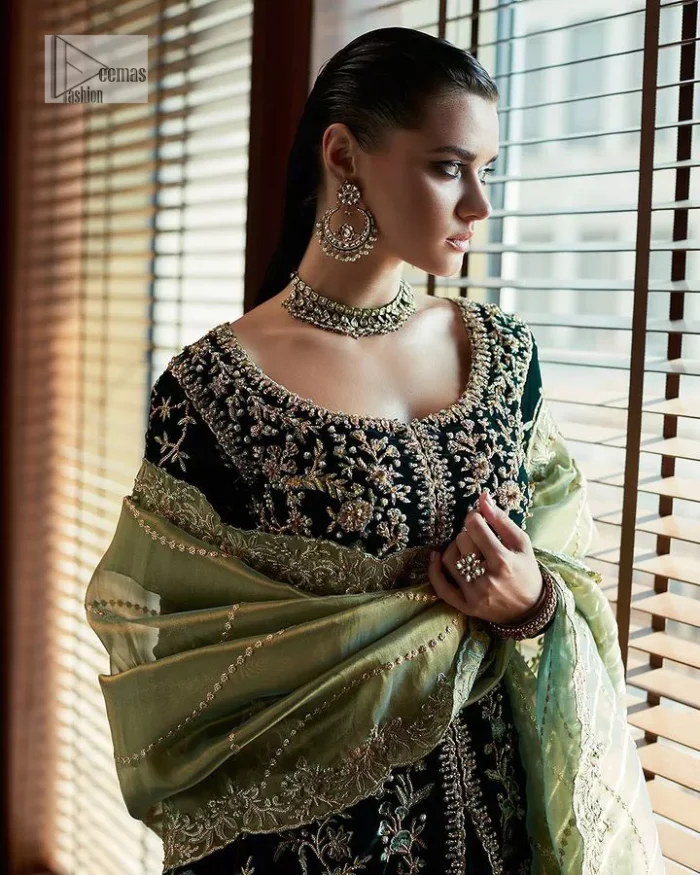 Outfits that define you. DeemasFashion presents the party wear in deep green colour which is adorned with light golden embroidery. It is enhanced with tilla, dabka, kora Kundan and the real magic of Zardozi. The round neckline makes this epitome of beauty. Furthermore, the full sleeves of the front open gown intensify the beauty of the outfit. It is coordinated with a plain lehenga with a border embellished to make you feel fresh and bold at the same time. Complete this attire with a dupatta in ivory colour which is ornamented with a four-sided embellished border to give a royal touch.