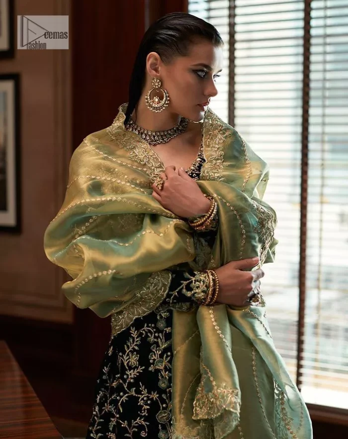Outfits that define you. DeemasFashion presents the party wear in deep green colour which is adorned with light golden embroidery. It is enhanced with tilla, dabka, kora Kundan and the real magic of Zardozi. The round neckline makes this epitome of beauty. Furthermore, the full sleeves of the front open gown intensify the beauty of the outfit. It is coordinated with a plain lehenga with a border embellished to make you feel fresh and bold at the same time. Complete this attire with a dupatta in ivory colour which is ornamented with a four-sided embellished border to give a royal touch.
