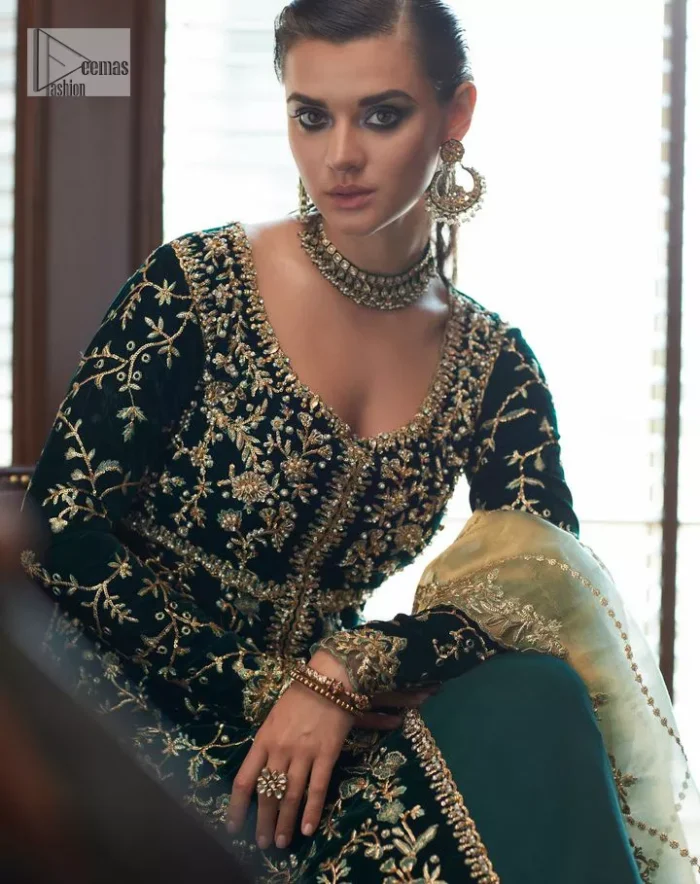 Outfits that define you. DeemasFashion presents the party wear in deep green colour which is adorned with light golden embroidery. It is enhanced with tilla, dabka, kora Kundan and the real magic of Zardozi. The round neckline makes this epitome of beauty. Furthermore, the full sleeves of the front open gown intensify the beauty of the outfit. It is coordinated with a plain lehenga with a border embellished to make you feel fresh and bold at the same time. Complete this attire with a dupatta in ivory colour which is ornamented with a four-sided embellished border to give a royal touch.