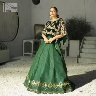 Style. Warmth. Performance & versatility!  This stuns in a beautifully handcrafted green top enshrined with light golden embellishment and detailed intricate floral & geometric patterns. The round neckline enhances the beauty of the outfit. Further, the floral designs on the sleeves make this outfit unique and attractive. It is coordinated with a plain organza lehenga in the same colour to balance your overall outfit. Collectively, this ensemble is the true essence of DeemasFashion bridals.
