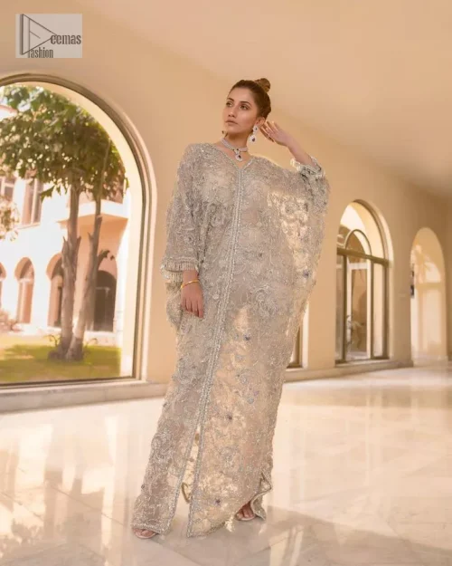 This dress transcends traditional boundaries, blending intricate details of kora, dabka, tilla, Kundan, and Zardozi in golden color and modern