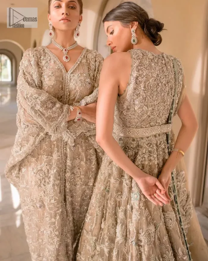 Your wedding vibe. Your wedding mood. Your wedding scent. The light fawn back train heavy maxi and dupatta are hand embellished with straight tilla, dabka, Kundan, Zardozi and kora with running hangings of pearls, crystals, and flat sequins. The sleeveless style of the following back train maxi gives a romantic touch to the whole walima wear. Further, the jewel neckline makes this symbol of beauty. It is paired up with a dupatta framed with a four-sided embellished border with our statement floral pattern and sprayed sequins to make you feel fresh and bold.