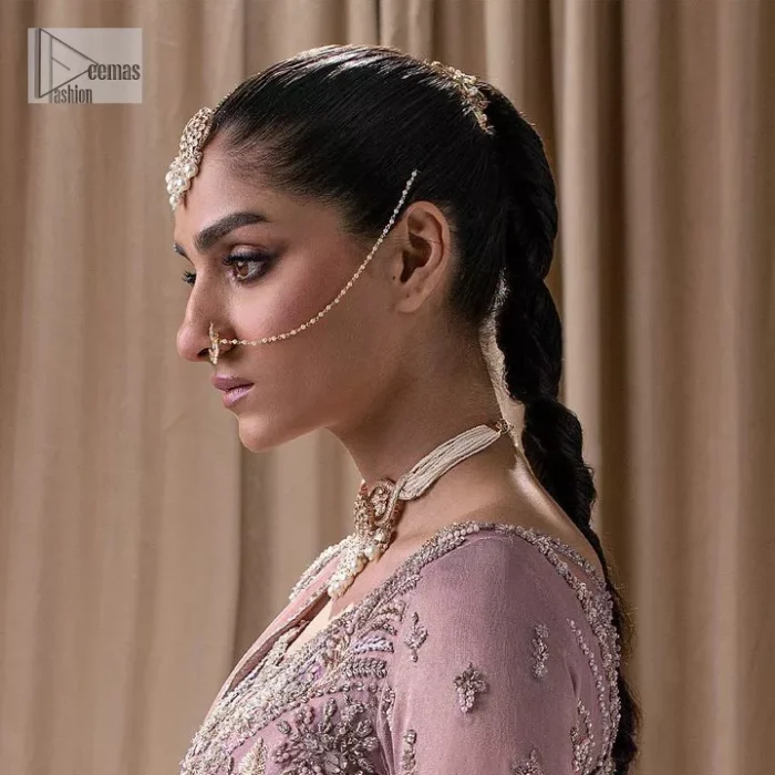 Stand out and stay pink with this nikah wear! The delightful article in pink colour is a traditional masterpiece that will give the gorgeous bride a head-turning look at the wedding. The frock has a sweetheart neckline to make this outfit lovely. It is adorned with silver and golden embroidery which is magnified with tilla, dabka, Koran, Kundan and the details of Zardozi. Further, the combination of tiny and large floral motifs on full sleeves provides a perfect finishing look to this masterpiece. It is paired up with a lehenga in the same colour making it an epitome of beauty and grace. Finish this with a dupatta framed with four-sided embellished scalloped borders and tiny floral motifs all over.