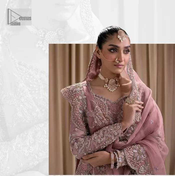Stand out and stay pink with this nikah wear! The delightful article in pink colour is a traditional masterpiece that will give the gorgeous bride a head-turning look at the wedding. The frock has a sweetheart neckline to make this outfit lovely. It is adorned with silver and golden embroidery which is magnified with tilla, dabka, Koran, Kundan and the details of Zardozi. Further, the combination of tiny and large floral motifs on full sleeves provides a perfect finishing look to this masterpiece. It is paired up with a lehenga in the same colour making it an epitome of beauty and grace. Finish this with a dupatta framed with four-sided embellished scalloped borders and tiny floral motifs all over.