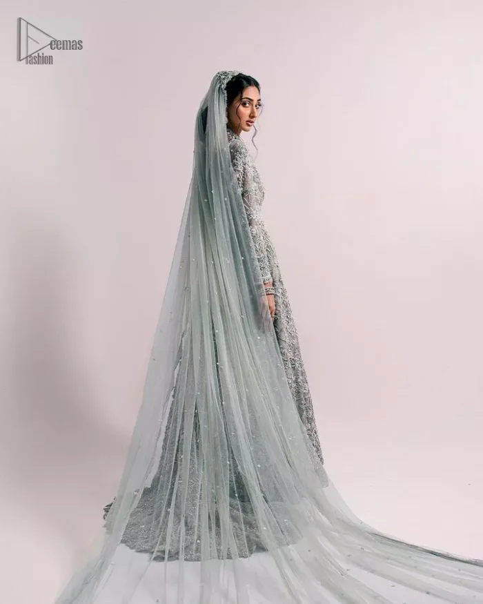 The beautiful mint green reception wear is a breathtaking masterpiece that will give you a magnificent look at the wedding. Lavish embroidery work and hand-crafted embellishments provide a perfect finishing look to this pishwas. It is adorned with silver embroidery which involves tilla, dabka, kora, Kundan and the real magic of zardozi. Further, the V shape neckline makes this masterpiece unique and attractive. The full sleeves are full of floral embroidery patterns. It is paired up with a lehenga with embroidered border to balance the outfit's look. The dress achieves the final elegant look when paired with a delicate dupatta embellished with four-sided scalloped edges and tiny floral motifs all over.