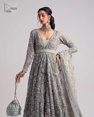 The beautiful mint green reception wear is a breathtaking masterpiece that will give you a magnificent look at the wedding. Lavish embroidery work and hand-crafted embellishments provide a perfect finishing look to this pishwas. It is adorned with silver embroidery which involves tilla, dabka, kora, Kundan and the real magic of zardozi. Further, the V shape neckline makes this masterpiece unique and attractive. The full sleeves are full of floral embroidery patterns. It is paired up with a lehenga with embroidered border to balance the outfit's look. The dress achieves the final elegant look when paired with a delicate dupatta embellished with four-sided scalloped edges and tiny floral motifs all over.