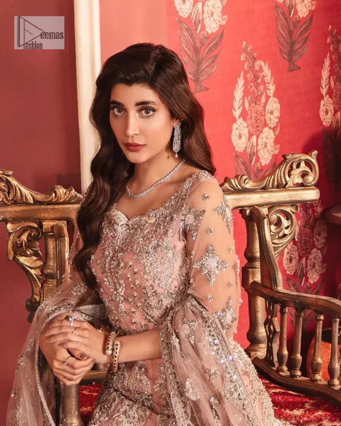 The beautiful outfit comes has an alluring peach colour and is gracefully emblazoned with embroidery. Hand-crafted details of tilla, dabka, kora, Kundan, stones, motifs, and sequins enhance the charm of this outfit. The sweetheart neckline makes this blouse a little more romantic for your walima day. Further, the floral motifs on half sleeves are just a new trend of looming on your day. It is organized with a heavy lehenga. Beaming silver work, floral designs, and lavish details give a perfect finishing look to the masterpiece. Complete this attire with a dupatta framed with a four-sided borders and floral motifs all over.