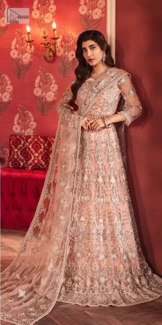 The beautiful outfit comes has an alluring peach colour and is gracefully emblazoned with embroidery. Hand-crafted details of tilla, dabka, kora, Kundan, stones, motifs, and sequins enhance the charm of this outfit. The sweetheart neckline makes this blouse a little more romantic for your walima day. Further, the floral motifs on half sleeves are just a new trend of looming on your day. It is organized with a heavy lehenga. Beaming silver work, floral designs, and lavish details give a perfect finishing look to the masterpiece. Complete this attire with a dupatta framed with a four-sided borders and floral motifs all over.