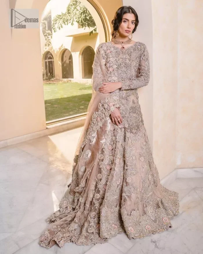 Let your nikah outfit do the talking.  An elegant rhyme to tradition, this short shirt and lehenga create aesthetical magic with its eye-catching hues of rose pink. The beautiful article shines with silver embellishments and an amalgamation of floral patterns which is enhanced with tilla, dabka, kora, Kundan and the detailing of Zardozi.  The full sleeves are heavily embroidered with floral patterns. Further, the V shape neckline makes this epitome of beauty. The lehenga is also intensified with beautiful embroidery. The perfect opulent short-shirt lehenga outfit is paired with an organza dupatta which is adorned with a four-sided embellished border and sequins sprayed all over