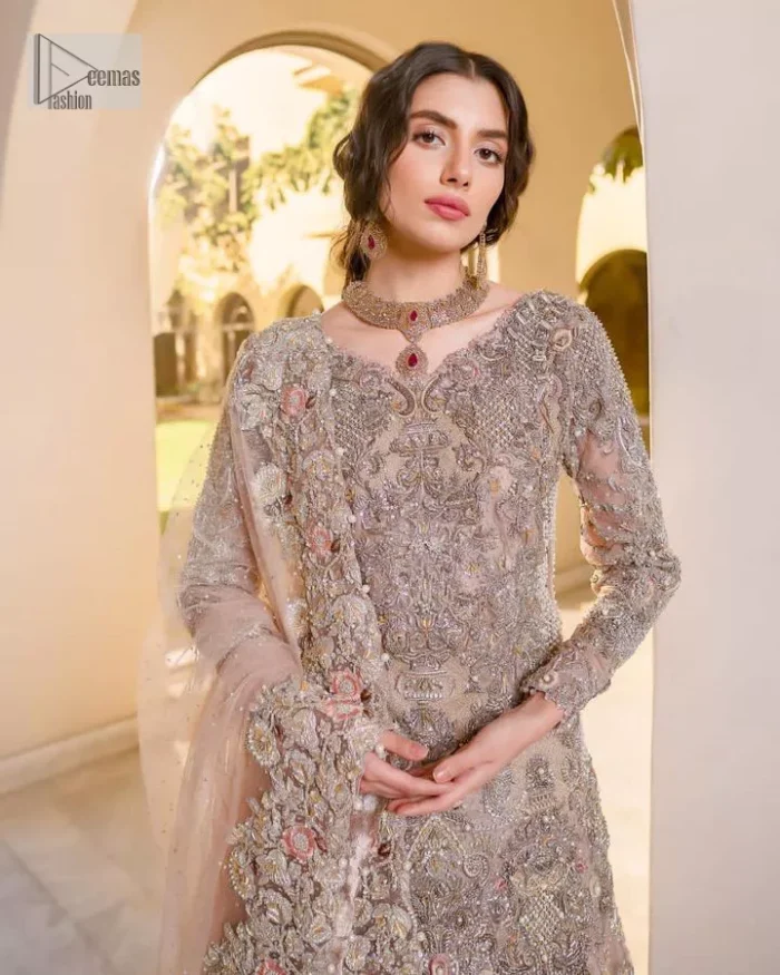 Let your nikah outfit do the talking.  An elegant rhyme to tradition, this short shirt and lehenga create aesthetical magic with its eye-catching hues of rose pink. The beautiful article shines with silver embellishments and an amalgamation of floral patterns which is enhanced with tilla, dabka, kora, Kundan and the detailing of Zardozi.  The full sleeves are heavily embroidered with floral patterns. Further, the V shape neckline makes this epitome of beauty. The lehenga is also intensified with beautiful embroidery. The perfect opulent short-shirt lehenga outfit is paired with an organza dupatta which is adorned with a four-sided embellished border and sequins sprayed all over