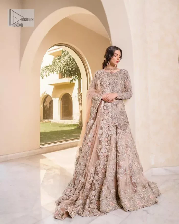 Let your nikah outfit do the talking.  An elegant rhyme to tradition, this short shirt and lehenga create aesthetical magic with its eye-catching hues of rose pink. The beautiful article shines with silver embellishments and an amalgamation of floral patterns which is enhanced with tilla, dabka, kora, Kundan and the detailing of Zardozi.  The full sleeves are heavily embroidered with floral patterns. Further, the V shape neckline makes this epitome of beauty. The lehenga is also intensified with beautiful embroidery. The perfect opulent short-shirt lehenga outfit is paired with an organza dupatta which is adorned with a four-sided embellished border and sequins sprayed all over