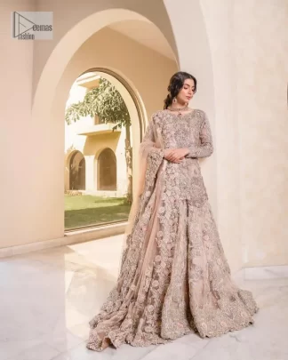 Let your nikah outfit do the talking.  An elegant rhyme to tradition, this short shirt and lehenga create aesthetical magic with its eye-catching hues of rose pink. The beautiful article shines with silver embellishments and an amalgamation of floral patterns which is enhanced with tilla, dabka, kora, Kundan and the detailing of Zardozi.  The full sleeves are heavily embroidered with floral patterns. Further, the V shape neckline makes this epitome of beauty. The lehenga is also intensified with beautiful embroidery. The perfect opulent short-shirt lehenga outfit is paired with an organza dupatta which is adorned with a four-sided embellished border and sequins sprayed all over
