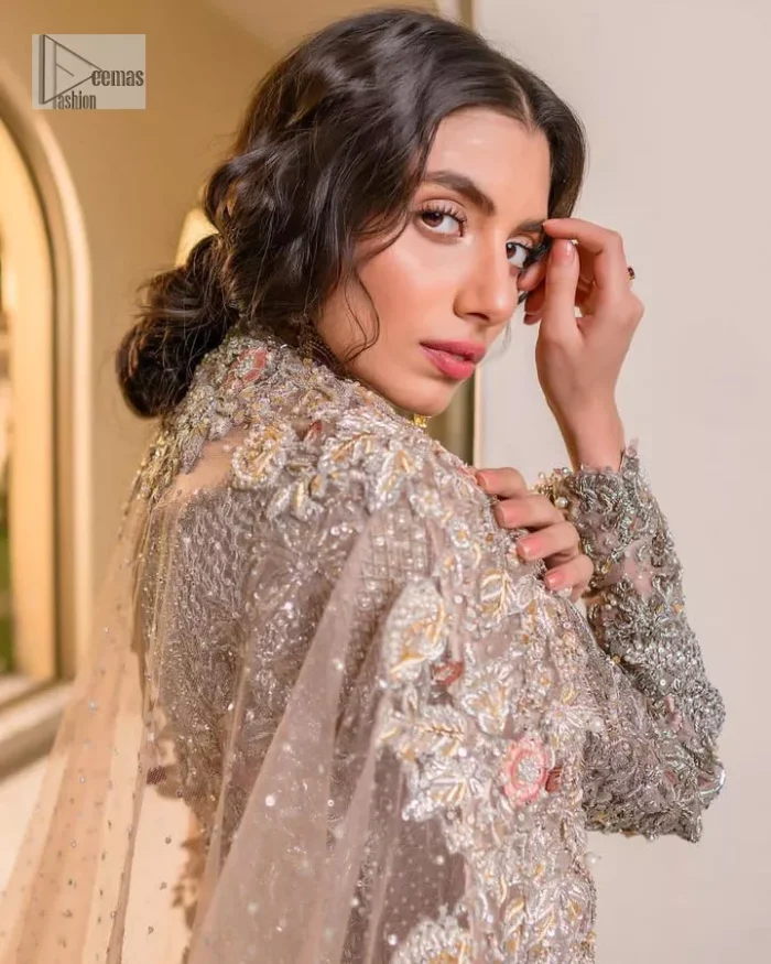 Let your nikah outfit do the talking.  An elegant rhyme to tradition, this short shirt and lehenga create aesthetical magic with its eye-catching hues of rose pink. The beautiful article shines with silver embellishments and an amalgamation of floral patterns which is enhanced with tilla, dabka, kora, Kundan and the detailing of Zardozi.  The full sleeves are heavily embroidered with floral patterns. Further, the V shape neckline makes this epitome of beauty. The lehenga is also intensified with beautiful embroidery. The perfect opulent short-shirt lehenga outfit is paired with an organza dupatta which is adorned with a four-sided embellished border and sequins sprayed all over