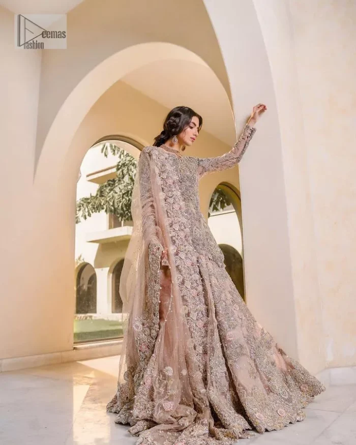 Let your nikah outfit do the talking.  An elegant rhyme to tradition, this short shirt and lehenga create aesthetical magic with its eye-catching hues of rose pink. The beautiful article shines with silver embellishments and an amalgamation of floral patterns which is enhanced with tilla, dabka, kora, Kundan and the detailing of Zardozi.  The full sleeves are heavily embroidered with floral patterns. Further, the V shape neckline makes this epitome of beauty. The lehenga is also intensified with beautiful embroidery. The perfect opulent short-shirt lehenga outfit is paired with an organza dupatta which is adorned with a four-sided embellished border and sequins sprayed all over