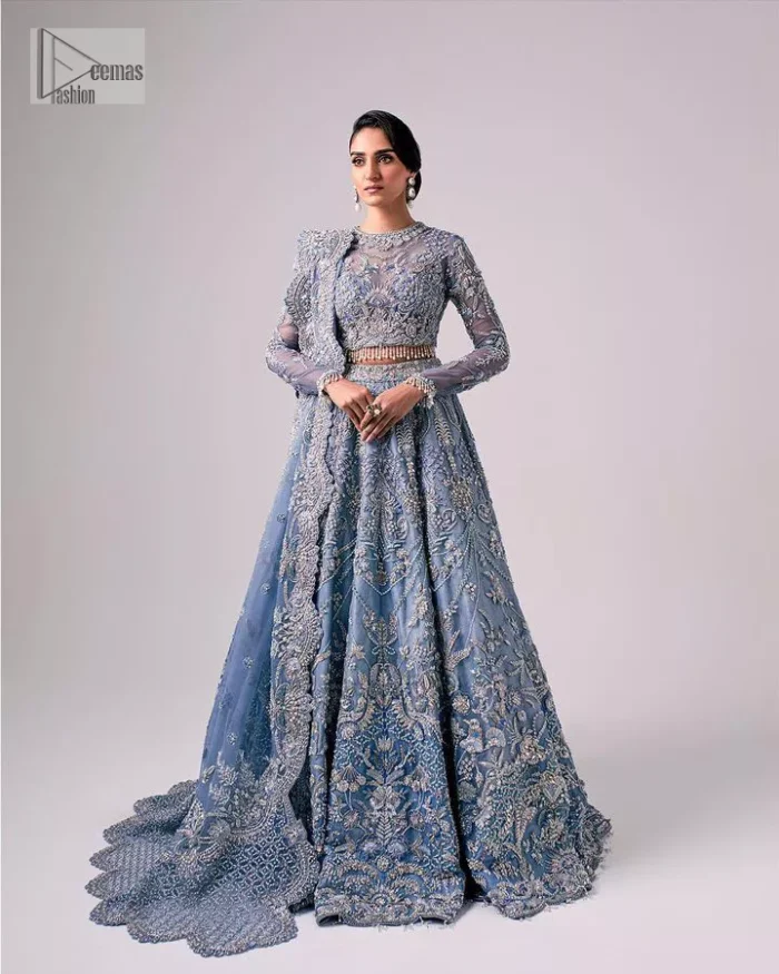 Stay blue and look your best! A sky blue lehenga choli is hand embellished with floral patterns and botanical motifs. The blouse is encrusted with silver embroidery which is enhanced with tilla, dabka, kora, Kundan and the real magic of Zardozi. The jewel neckline and full sleeves make this masterpiece lovely and charming. It is paired up with a lehenga in the same colour that has embellished on the front and back finish. Complete the walima wear with a dupatta having four-sided Kiran and tiny floral motifs all over just to complete the look.