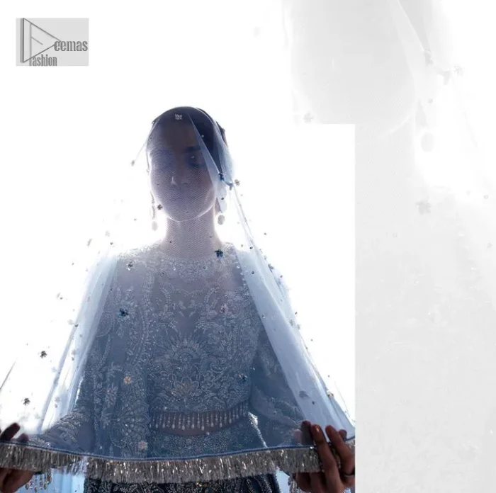 Stay blue and look your best! A sky blue lehenga choli is hand embellished with floral patterns and botanical motifs. The blouse is encrusted with silver embroidery which is enhanced with tilla, dabka, kora, Kundan and the real magic of Zardozi. The jewel neckline and full sleeves make this masterpiece lovely and charming. It is paired up with a lehenga in the same colour that has embellished on the front and back finish. Complete the walima wear with a dupatta having four-sided Kiran and tiny floral motifs all over just to complete the look.