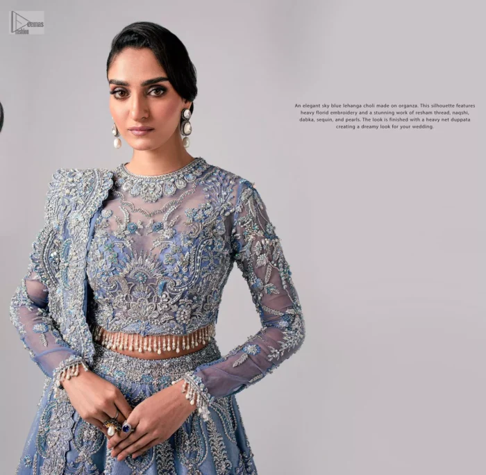 Stay blue and look your best! A sky blue lehenga choli is hand embellished with floral patterns and botanical motifs. The blouse is encrusted with silver embroidery which is enhanced with tilla, dabka, kora, Kundan and the real magic of Zardozi. The jewel neckline and full sleeves make this masterpiece lovely and charming. It is paired up with a lehenga in the same colour that has embellished on the front and back finish. Complete the walima wear with a dupatta having four-sided Kiran and tiny floral motifs all over just to complete the look.