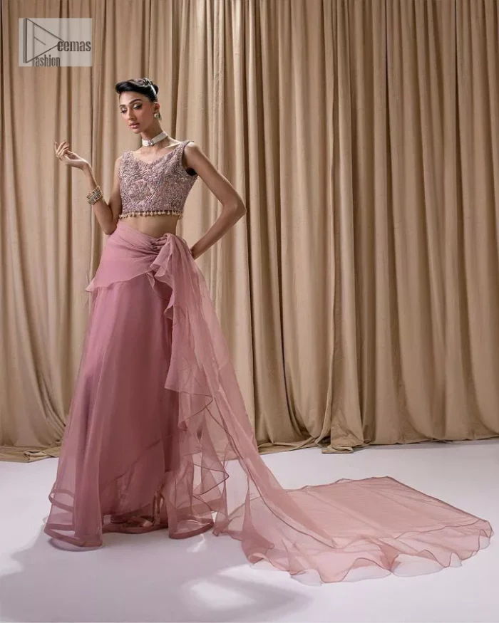 Turn heads in our stunning bridesmaid saree! The beautiful tea pink blouse is adorned with silver and golden embroidery which is intensified with tilla, dabka, kora, Kundan and the details of Zardozi. The V shape neckline provides a perfect finishing look to this masterpiece. In addition to this, the sleeveless style of the following blouse makes this outfit unique and romantic. It is paired up with a frilled saree which is plain just to enhance the beauty of this lovely outfit. 