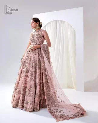 Matching embellishments are here to stay. The attractive tea pink nikah article is a stunning attire adorned with tilla, dabka, kora, Kundan, Zardozi and Gota.  Hand-crafted embellishments of golden and silver embroidery and floral patterns give a perfect finishing look to the maxi. The following scalloped maxi has a jewel neckline to make this unique and charming. In addition to this, the sleeveless style of the maxi is a breathtaking masterpiece that will give the gorgeous bride a breathtaking traditional look at the wedding. It is paired up with a plain lehenga to balance the astonishing look. Finish this with a dupatta that has four-sided embellished borders and tiny floral motifs all over to make your day glow and flowery.