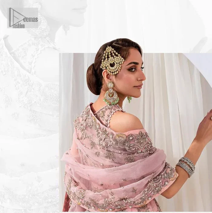 Matching embellishments are here to stay. The attractive tea pink nikah article is a stunning attire adorned with tilla, dabka, kora, Kundan, Zardozi and Gota.  Hand-crafted embellishments of golden and silver embroidery and floral patterns give a perfect finishing look to the maxi. The following scalloped maxi has a jewel neckline to make this unique and charming. In addition to this, the sleeveless style of the maxi is a breathtaking masterpiece that will give the gorgeous bride a breathtaking traditional look at the wedding. It is paired up with a plain lehenga to balance the astonishing look. Finish this with a dupatta that has four-sided embellished borders and tiny floral motifs all over to make your day glow and flowery.