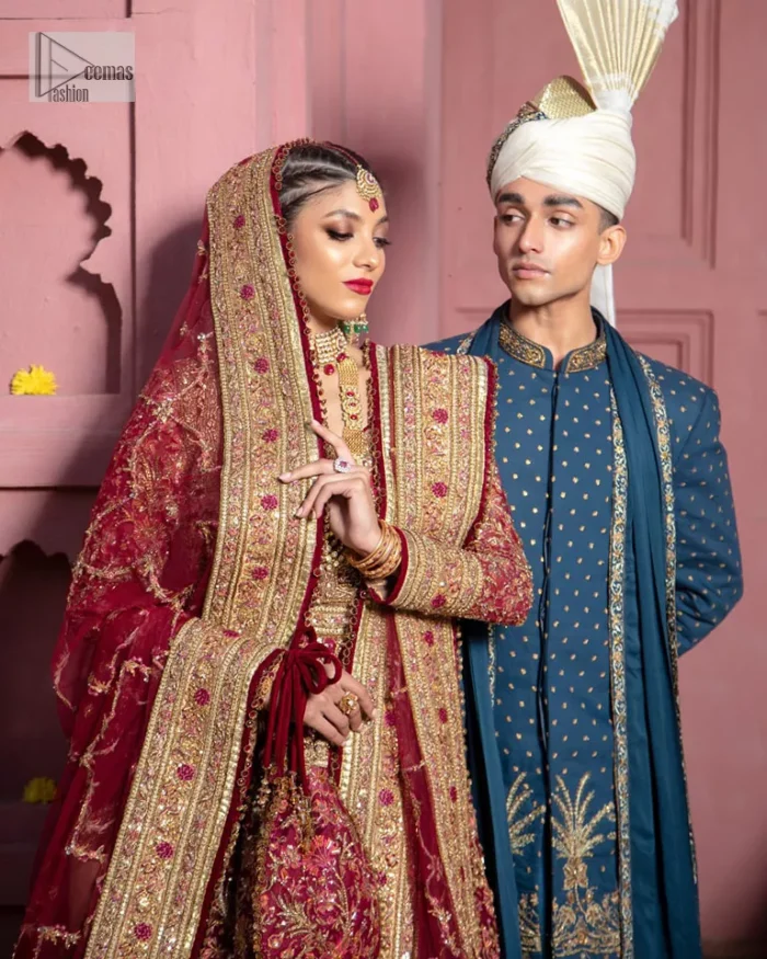 Deep shades of this reception wear just to brighten up your days. The deep red frock is intricately emblazoned with golden embellishments. Red floral designs and threads give an elegant touch to the frock Graceful details of tilla, dabka, kora, Kundan and Zardozi make this beautiful frock a perfect choice to pair with Wedding sharara. The round neckline of the following blouse intensifies the beauty. Furthermore, the full sleeves are decorated with floral patterns. The following deep red frock is coordinated with fish cut sharara having detailed embroidery. Complete this outfit with a dupatta framed with four-sided borders and floral jaal all over.