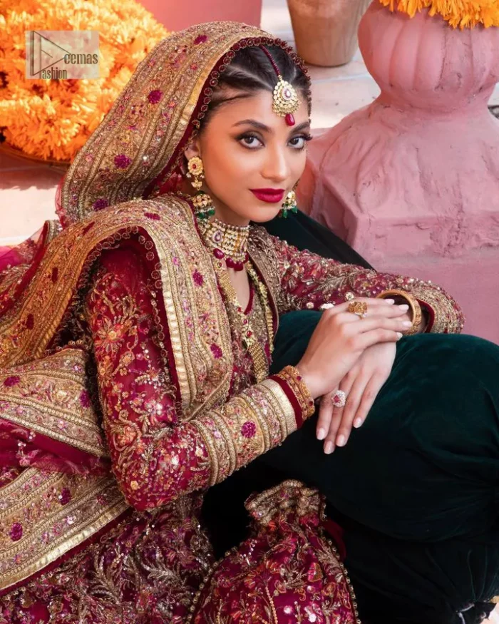 Deep shades of this reception wear just to brighten up your days. The deep red frock is intricately emblazoned with golden embellishments. Red floral designs and threads give an elegant touch to the frock Graceful details of tilla, dabka, kora, Kundan and Zardozi make this beautiful frock a perfect choice to pair with Wedding sharara. The round neckline of the following blouse intensifies the beauty. Furthermore, the full sleeves are decorated with floral patterns. The following deep red frock is coordinated with fish cut sharara having detailed embroidery. Complete this outfit with a dupatta framed with four-sided borders and floral jaal all over.