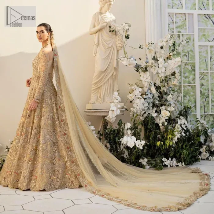 Make a statement wherever you go with a great selection of fawn colours just for you! A beautiful fawn scalloped maxi with a medley of hand-embellished floral motifs and geometric patterns in silver and gold colour. The maxi is enhanced with tilla, dabka, kora, Kundan and the real magic of Zardozi. The V shape neckline makes this walima outfit charming and attractive. Further, the patterns on full sleeves also intensify its loveliness. It is paired with an embellished floral border lehenga served with a scalloped. A net dupatta with sequin spray and intricate borders completes a gorgeous outfit.