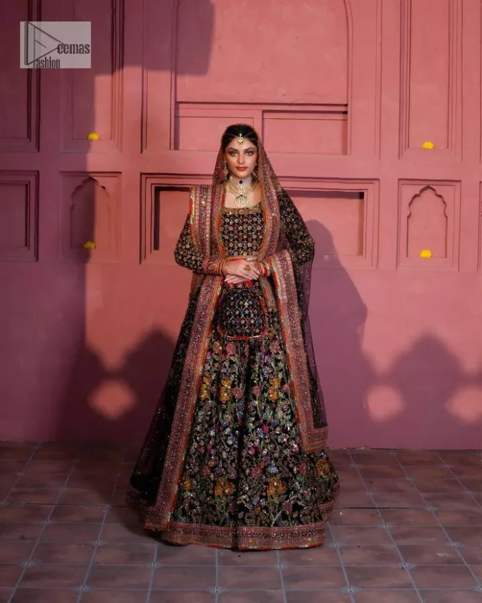 Make your superb days bright and bold! A jet black blouse with floral branches, peacock motifs and Mughal-inspired embellishments with dabka, naqshi, cut dana, Resham, Swarovski, Zardozi, tilla and Kundan. It is supported with a round neckline and full sleeves to make this masterpiece a traditional look. The lehenga has an embellished border around its flare that is complemented and decorated with multiple colour embroidery. It is paired with an organza dupatta in the same colour with a sequin-sprayed surface and intricately embellished borders on all sides.