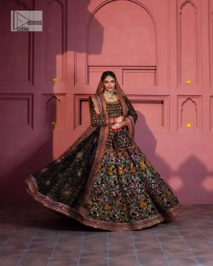 Make your superb days bright and bold! A jet black blouse with floral branches, peacock motifs and Mughal-inspired embellishments with dabka, naqshi, cut dana, Resham, Swarovski, Zardozi, tilla and Kundan. It is supported with a round neckline and full sleeves to make this masterpiece a traditional look. The lehenga has an embellished border around its flare that is complemented and decorated with multiple colour embroidery. It is paired with an organza dupatta in the same colour with a sequin-sprayed surface and intricately embellished borders on all sides.