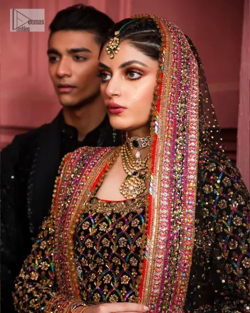 Make your superb days bright and bold! A jet black blouse with floral branches, peacock motifs and Mughal-inspired embellishments with