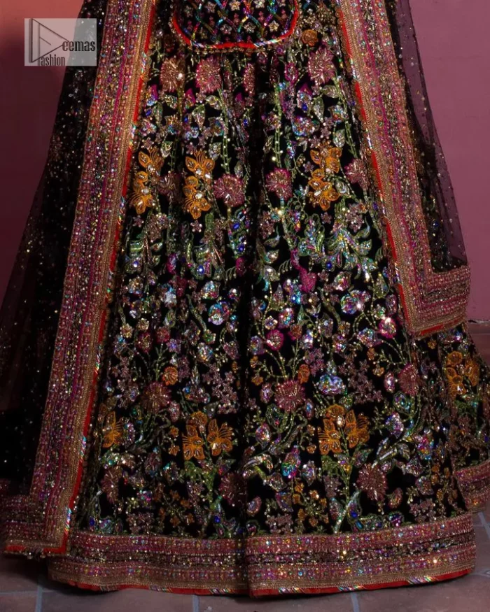 Make your superb days bright and bold! A jet black blouse with floral branches, peacock motifs and Mughal-inspired embellishments with dabka, naqshi, cut dana, Resham, Swarovski, Zardozi, tilla and Kundan. It is supported with a round neckline and full sleeves to make this masterpiece a traditional look. The lehenga has an embellished border around its flare that is complemented and decorated with multiple colour embroidery. It is paired with an organza dupatta in the same colour with a sequin-sprayed surface and intricately embellished borders on all sides.