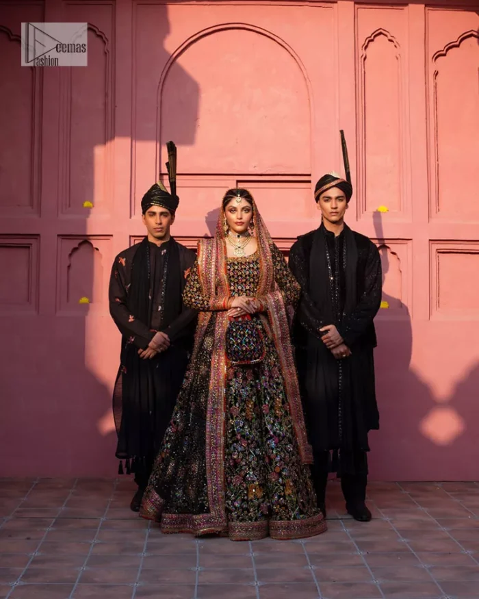 Make your superb days bright and bold! A jet black blouse with floral branches, peacock motifs and Mughal-inspired embellishments with dabka, naqshi, cut dana, Resham, Swarovski, Zardozi, tilla and Kundan. It is supported with a round neckline and full sleeves to make this masterpiece a traditional look. The lehenga has an embellished border around its flare that is complemented and decorated with multiple colour embroidery. It is paired with an organza dupatta in the same colour with a sequin-sprayed surface and intricately embellished borders on all sides.