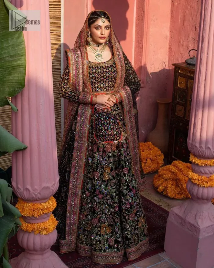Make your superb days bright and bold! A jet black blouse with floral branches, peacock motifs and Mughal-inspired embellishments with dabka, naqshi, cut dana, Resham, Swarovski, Zardozi, tilla and Kundan. It is supported with a round neckline and full sleeves to make this masterpiece a traditional look. The lehenga has an embellished border around its flare that is complemented and decorated with multiple colour embroidery. It is paired with an organza dupatta in the same colour with a sequin-sprayed surface and intricately embellished borders on all sides.