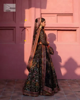 Make your superb days bright and bold! A jet black blouse with floral branches, peacock motifs and Mughal-inspired embellishments with dabka, naqshi, cut dana, Resham, Swarovski, Zardozi, tilla and Kundan. It is supported with a round neckline and full sleeves to make this masterpiece a traditional look. The lehenga has an embellished border around its flare that is complemented and decorated with multiple colour embroidery. It is paired with an organza dupatta in the same colour with a sequin-sprayed surface and intricately embellished borders on all sides.