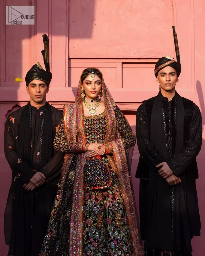 Make your superb days bright and bold! A jet black blouse with floral branches, peacock motifs and Mughal-inspired embellishments with dabka, naqshi, cut dana, Resham, Swarovski, Zardozi, tilla and Kundan. It is supported with a round neckline and full sleeves to make this masterpiece a traditional look. The lehenga has an embellished border around its flare that is complemented and decorated with multiple colour embroidery. It is paired with an organza dupatta in the same colour with a sequin-sprayed surface and intricately embellished borders on all sides.
