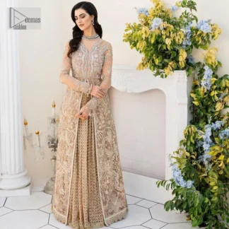 Ultra feminine look in an enthralling shade of brown for an aesthetically pleasing style statement. The beautiful light brown front open scalloped maxi with a medley of hand-embellished floral motifs of silver colour is intensified with tilla, dabka, Kora, Kundan and details of Zardozi. The neckline has an embellished V shape to add elegance and sophistication. Further, the full sleeve style of the following maxi enhances the charms. It is paired with a flared lehenga to complete the view of the nikah article. A frilled net dupatta is finished to complete a gorgeous outfit.