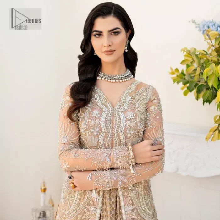 Ultra feminine look in an enthralling shade of brown for an aesthetically pleasing style statement. The beautiful light brown front open scalloped maxi with a medley of hand-embellished floral motifs of silver colour is intensified with tilla, dabka, Kora, Kundan and details of Zardozi. The neckline has an embellished V shape to add elegance and sophistication. Further, the full sleeve style of the following maxi enhances the charms. It is paired with a flared lehenga to complete the view of the nikah article. A frilled net dupatta is finished to complete a gorgeous outfit.