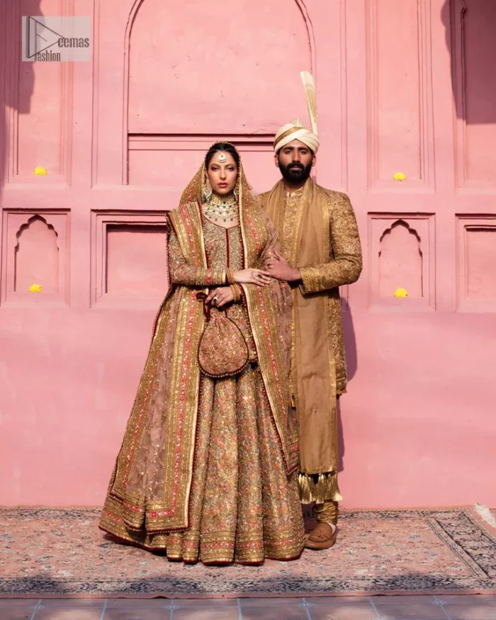 Create a look that’s for you with just one twist of this reception wear. A soft brown short shirt heavily embellished with tilla, dabka, Kora, Zardozi and Kundan. This beautiful dress has Mughal-inspired motifs, geometrical patterns, floral motifs and appliquéd silks. The round neckline makes this masterpiece unique and lovely. In addition to this, the full sleeves also admire its beauty. A lehenga supports it with an embellished border. The organza dupatta has a sequin-sprayed surface with branching floral motifs and it is enveloped with four-sided beautiful borders.