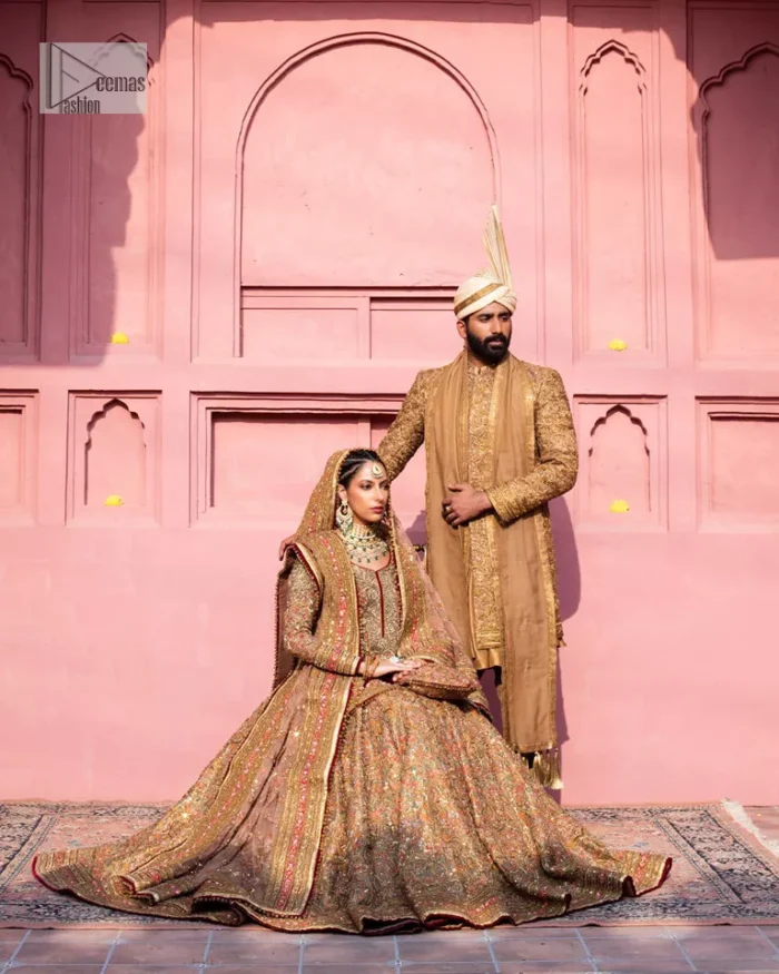 Create a look that’s for you with just one twist of this reception wear. A soft brown short shirt heavily embellished with tilla, dabka, Kora, Zardozi and Kundan. This beautiful dress has Mughal-inspired motifs, geometrical patterns, floral motifs and appliquéd silks. The round neckline makes this masterpiece unique and lovely. In addition to this, the full sleeves also admire its beauty. A lehenga supports it with an embellished border. The organza dupatta has a sequin-sprayed surface with branching floral motifs and it is enveloped with four-sided beautiful borders.