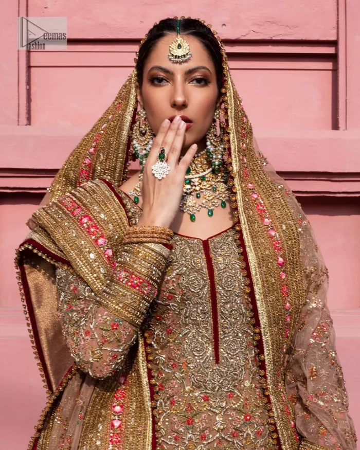 Create a look that’s for you with just one twist of this reception wear. A soft brown short shirt heavily embellished with tilla, dabka, Kora, Zardozi and Kundan. This beautiful dress has Mughal-inspired motifs, geometrical patterns, floral motifs and appliquéd silks. The round neckline makes this masterpiece unique and lovely. In addition to this, the full sleeves also admire its beauty. A lehenga supports it with an embellished border. The organza dupatta has a sequin-sprayed surface with branching floral motifs and it is enveloped with four-sided beautiful borders.