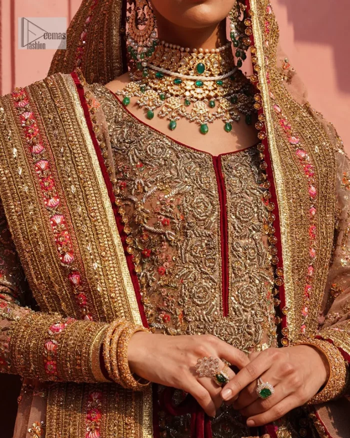 Create a look that’s for you with just one twist of this reception wear. A soft brown short shirt heavily embellished with tilla, dabka, Kora, Zardozi and Kundan. This beautiful dress has Mughal-inspired motifs, geometrical patterns, floral motifs and appliquéd silks. The round neckline makes this masterpiece unique and lovely. In addition to this, the full sleeves also admire its beauty. A lehenga supports it with an embellished border. The organza dupatta has a sequin-sprayed surface with branching floral motifs and it is enveloped with four-sided beautiful borders.