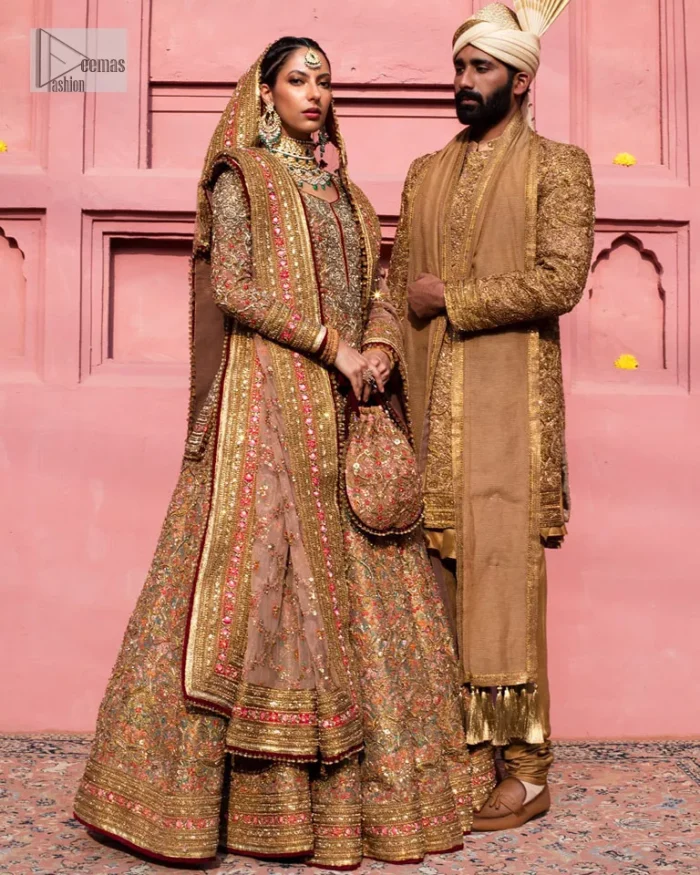 Create a look that’s for you with just one twist of this reception wear. A soft brown short shirt heavily embellished with tilla, dabka, Kora, Zardozi and Kundan. This beautiful dress has Mughal-inspired motifs, geometrical patterns, floral motifs and appliquéd silks. The round neckline makes this masterpiece unique and lovely. In addition to this, the full sleeves also admire its beauty. A lehenga supports it with an embellished border. The organza dupatta has a sequin-sprayed surface with branching floral motifs and it is enveloped with four-sided beautiful borders.