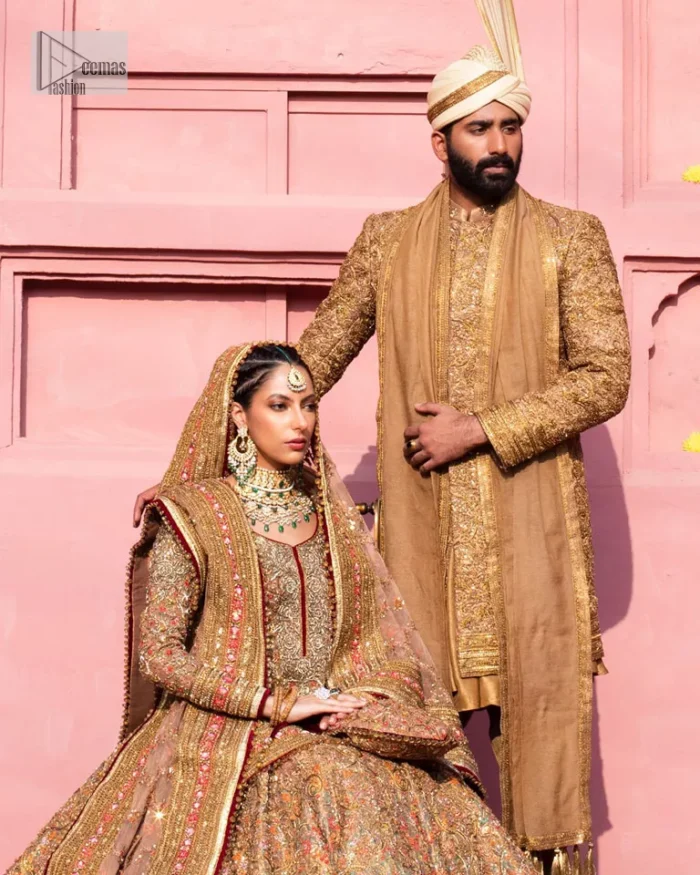 Create a look that’s for you with just one twist of this reception wear. A soft brown short shirt heavily embellished with tilla, dabka, Kora, Zardozi and Kundan. This beautiful dress has Mughal-inspired motifs, geometrical patterns, floral motifs and appliquéd silks. The round neckline makes this masterpiece unique and lovely. In addition to this, the full sleeves also admire its beauty. A lehenga supports it with an embellished border. The organza dupatta has a sequin-sprayed surface with branching floral motifs and it is enveloped with four-sided beautiful borders.