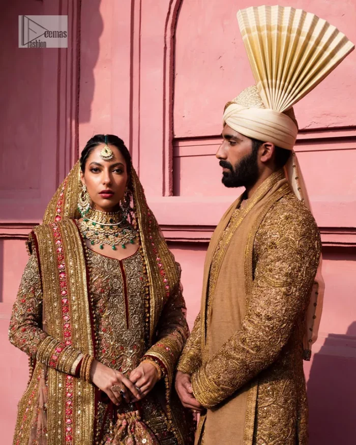 Create a look that’s for you with just one twist of this reception wear. A soft brown short shirt heavily embellished with tilla, dabka, Kora, Zardozi and Kundan. This beautiful dress has Mughal-inspired motifs, geometrical patterns, floral motifs and appliquéd silks. The round neckline makes this masterpiece unique and lovely. In addition to this, the full sleeves also admire its beauty. A lehenga supports it with an embellished border. The organza dupatta has a sequin-sprayed surface with branching floral motifs and it is enveloped with four-sided beautiful borders.