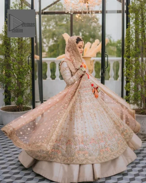 The frock in the light fawn has laden with multiple colour embroidery which makes this attire a head-turning masterpiece.