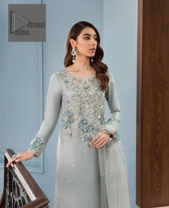 Timeless details that add an extra edge to your looks! Deemas Fashion presents this Party outfit, an embellished masterpiece that wins everyone’s hearts at first glance with its charm and elegance. The shirt in the Gray colour is laden with golden and teal embroidery, making this attire a head-turning masterpiece. Further, the round neckline is fully embellished with tilla, dabka, kora, Kundan, and pearls that give it a magical look. The full-sleeved style makes this outfit a little attractive but super charming. Complete this article with a dupatta, having a tiny floral motif all over to give you a decent look.