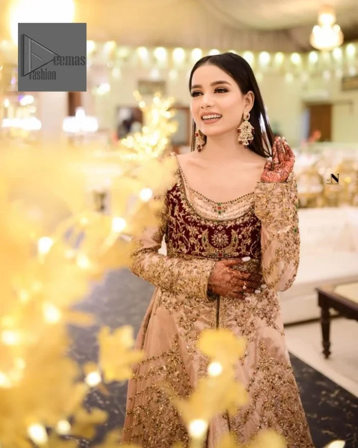 Your words about your special day is expertly written in this beautiful dress. This ivory front open gown is the picture of elegance and majesty. Silver dabka, pearls, tilla, kora, Kundan, zardozi, and the true magic of beads are used to embellish the stunning garment. Golden embroidery on it makes it stand out. The V-shaped neckline of the dress elevates this ensemble. Moreover, full sleeves are embellished with the lovely embroidery. Pairing the richly embroidered ivory gown with a set of simple frilled lehenga and inner frock would look stunning. To achieve professional magic, it is set up with a dupatta that is bordered with four-sided borders and spray of sequins all over.