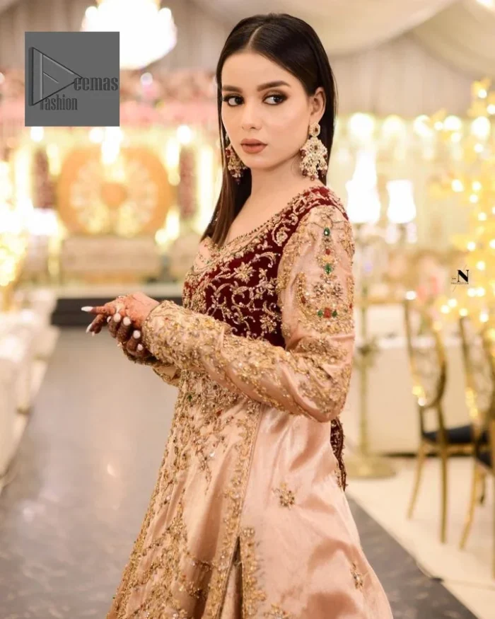 Your words about your special day is expertly written in this beautiful dress. This ivory front open gown is the picture of elegance and majesty. Silver dabka, pearls, tilla, kora, Kundan, zardozi, and the true magic of beads are used to embellish the stunning garment. Golden embroidery on it makes it stand out. The V-shaped neckline of the dress elevates this ensemble. Moreover, full sleeves are embellished with the lovely embroidery. Pairing the richly embroidered ivory gown with a set of simple frilled lehenga and inner frock would look stunning. To achieve professional magic, it is set up with a dupatta that is bordered with four-sided borders and spray of sequins all over.
