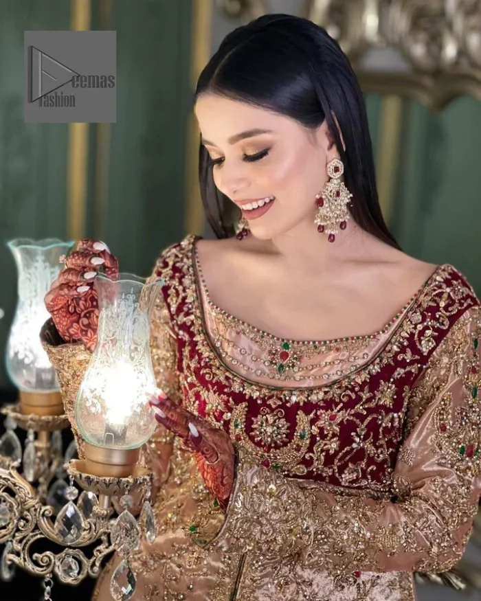Your words about your special day is expertly written in this beautiful dress. This ivory front open gown is the picture of elegance and majesty. Silver dabka, pearls, tilla, kora, Kundan, zardozi, and the true magic of beads are used to embellish the stunning garment. Golden embroidery on it makes it stand out. The V-shaped neckline of the dress elevates this ensemble. Moreover, full sleeves are embellished with the lovely embroidery. Pairing the richly embroidered ivory gown with a set of simple frilled lehenga and inner frock would look stunning. To achieve professional magic, it is set up with a dupatta that is bordered with four-sided borders and spray of sequins all over.